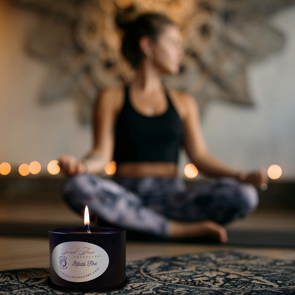 photograph of a young woman doing yoga while a scented candle from Theia's Apothecary burns in the foreground